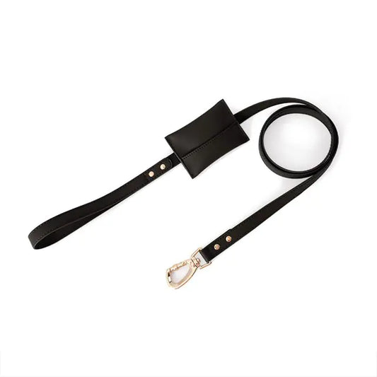 A black leather strap with a small attached pouch and a metal clasp at one end. The strap is coiled in a circular shape, and the pouch is positioned near the middle of the strap. The metal clasp is designed for attaching to another object, possibly for carrying or securing items. The leather appears to be of high quality, with visible stitching and metal rivets for reinforcement.