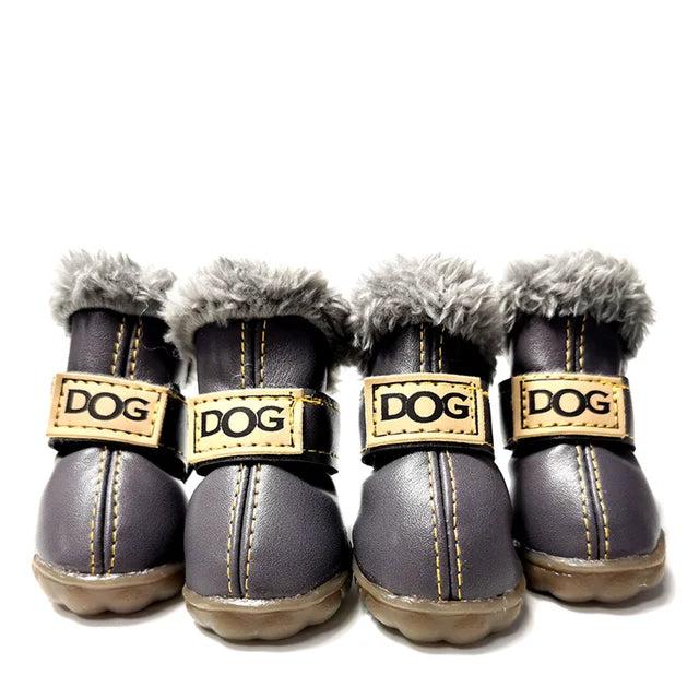 Four gray leather dog boots with grey fur lining, adjustable straps, and non-slip soles.
